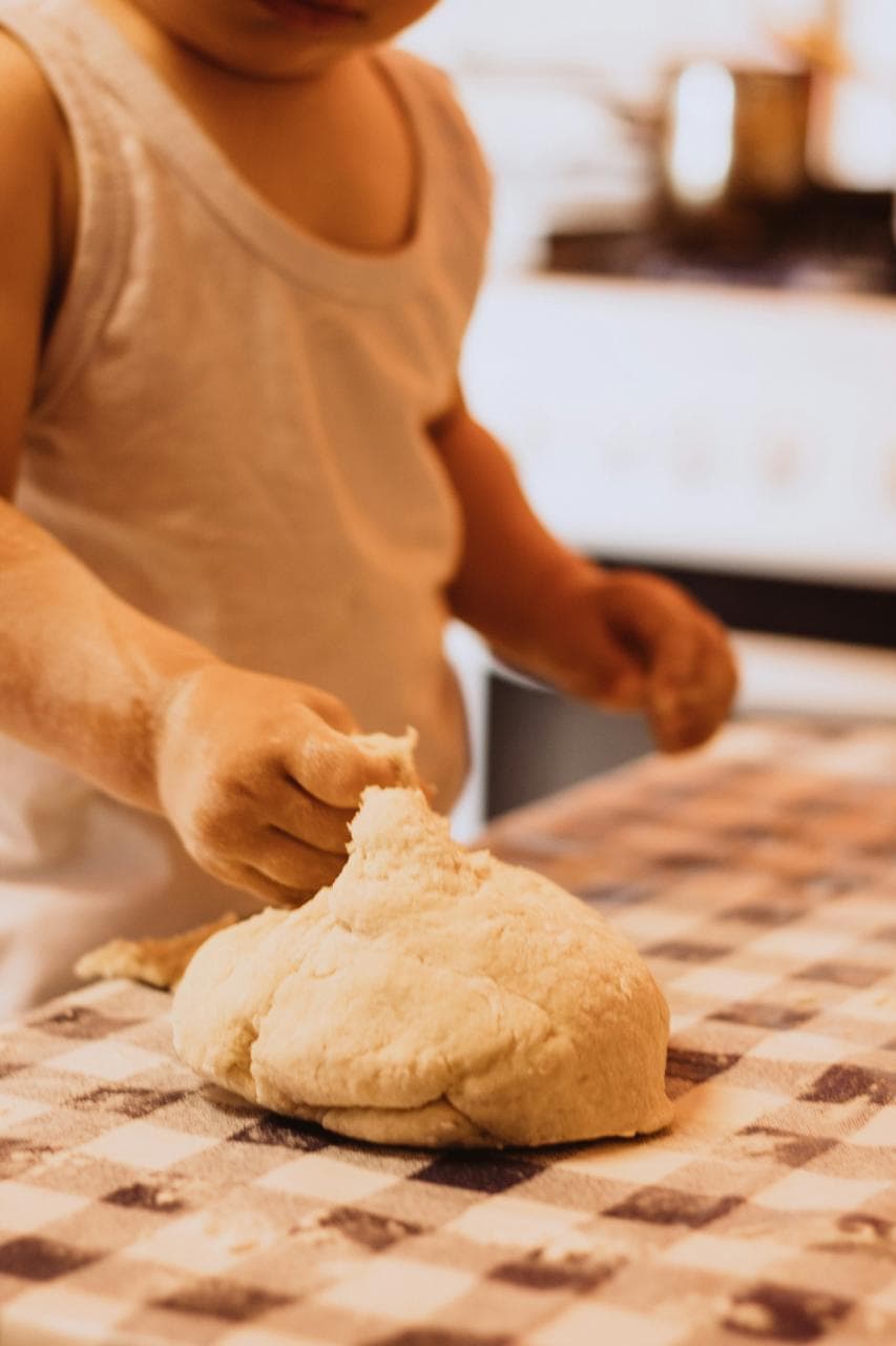 Child kneading dough